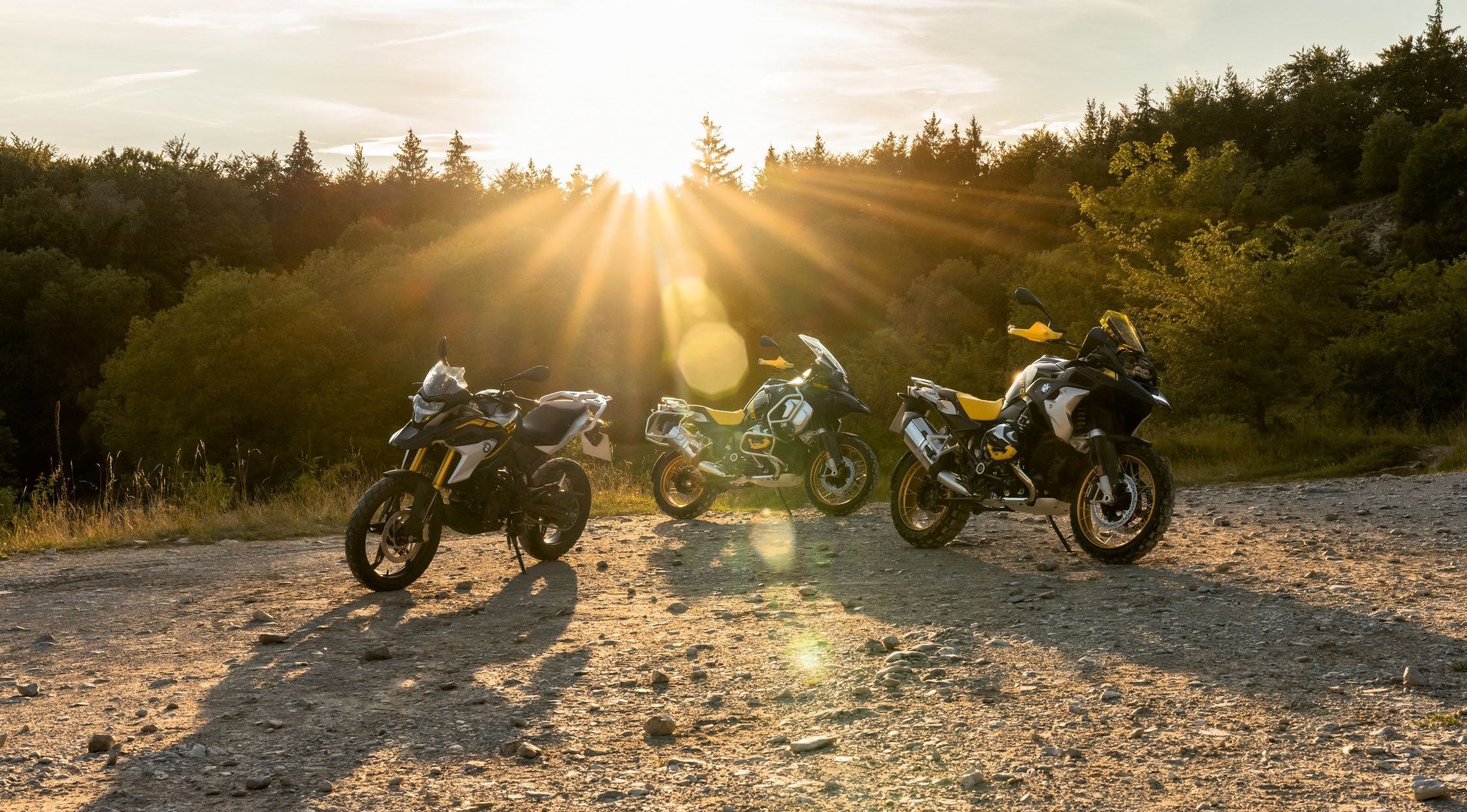 BMW Adventure motorcycles parked on enduro terrain