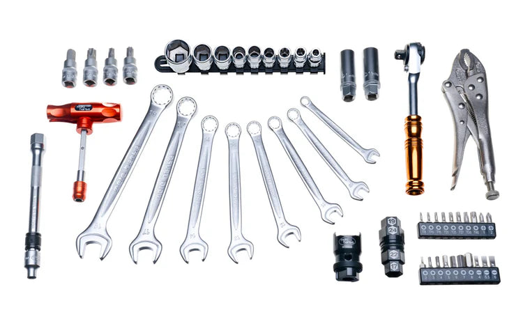 Collection of various tools including wrenches, sockets, and pliers on a white background
