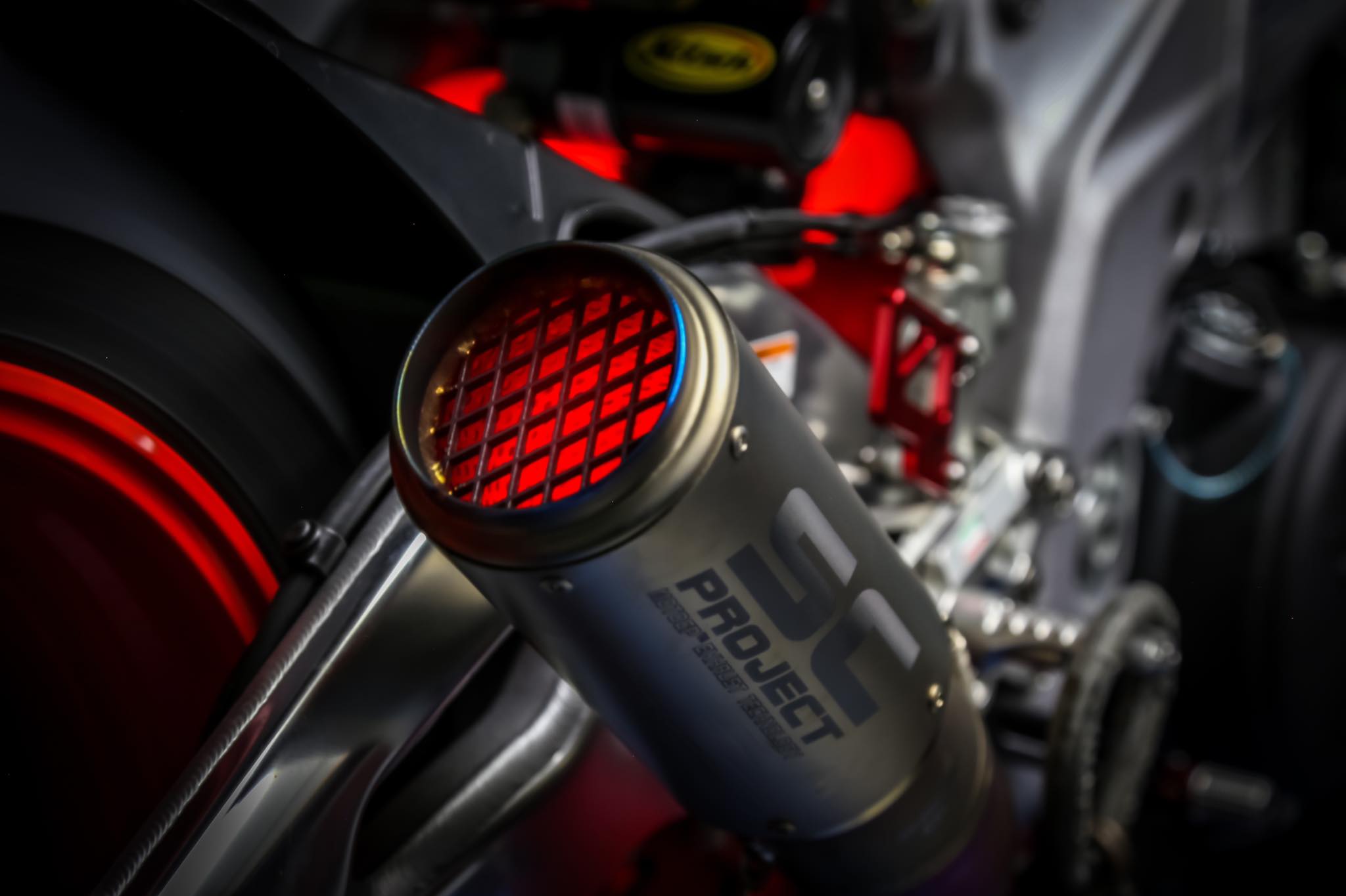 Close-up of a motorcycle exhaust with 'Project' branding