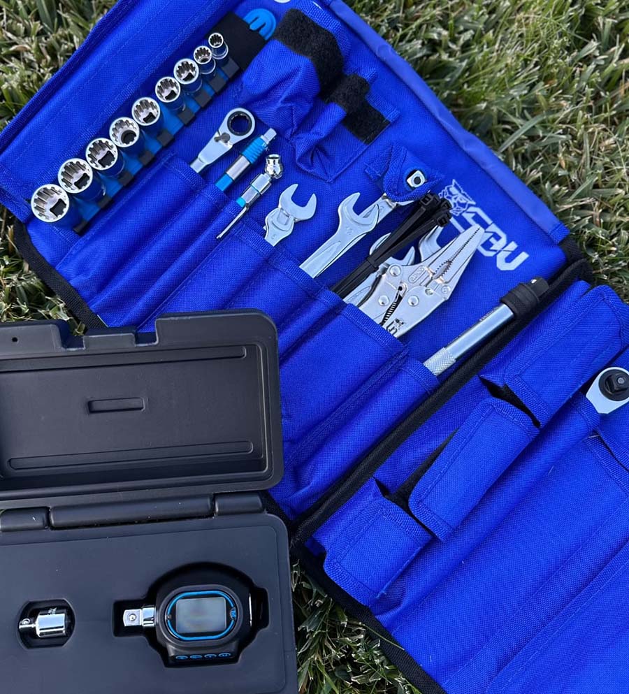 Blue tool set with tools and accessories on a grassy background