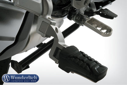 Passenger footrest relocation