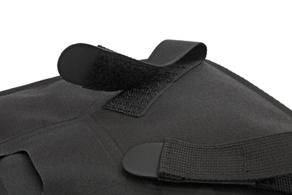 Black tactical vest with straps on a white background