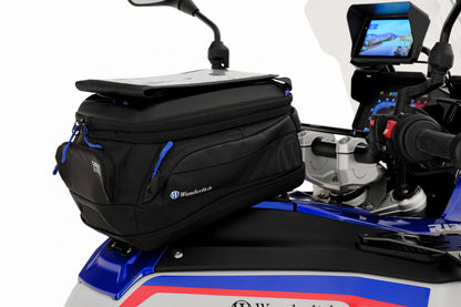 Black bag attached to a motorcycle with visible branding on a white background